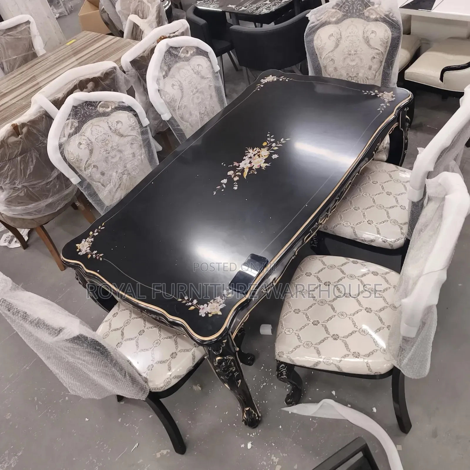Rococo-Style Black Dining With Floral Accents and Upholstered Chairs.