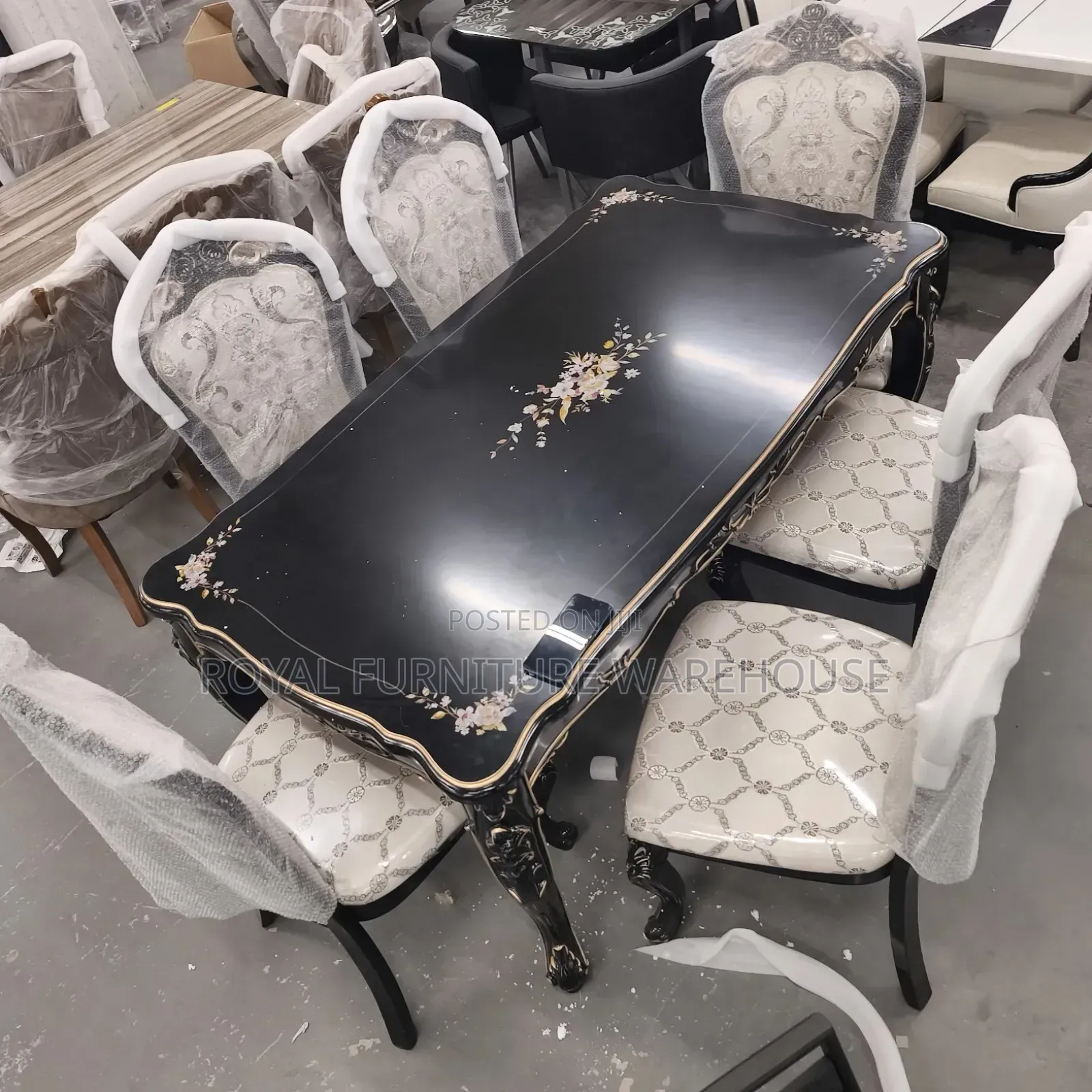 Rococo-Style Black Dining With Floral Accents and Upholstered Chairs.