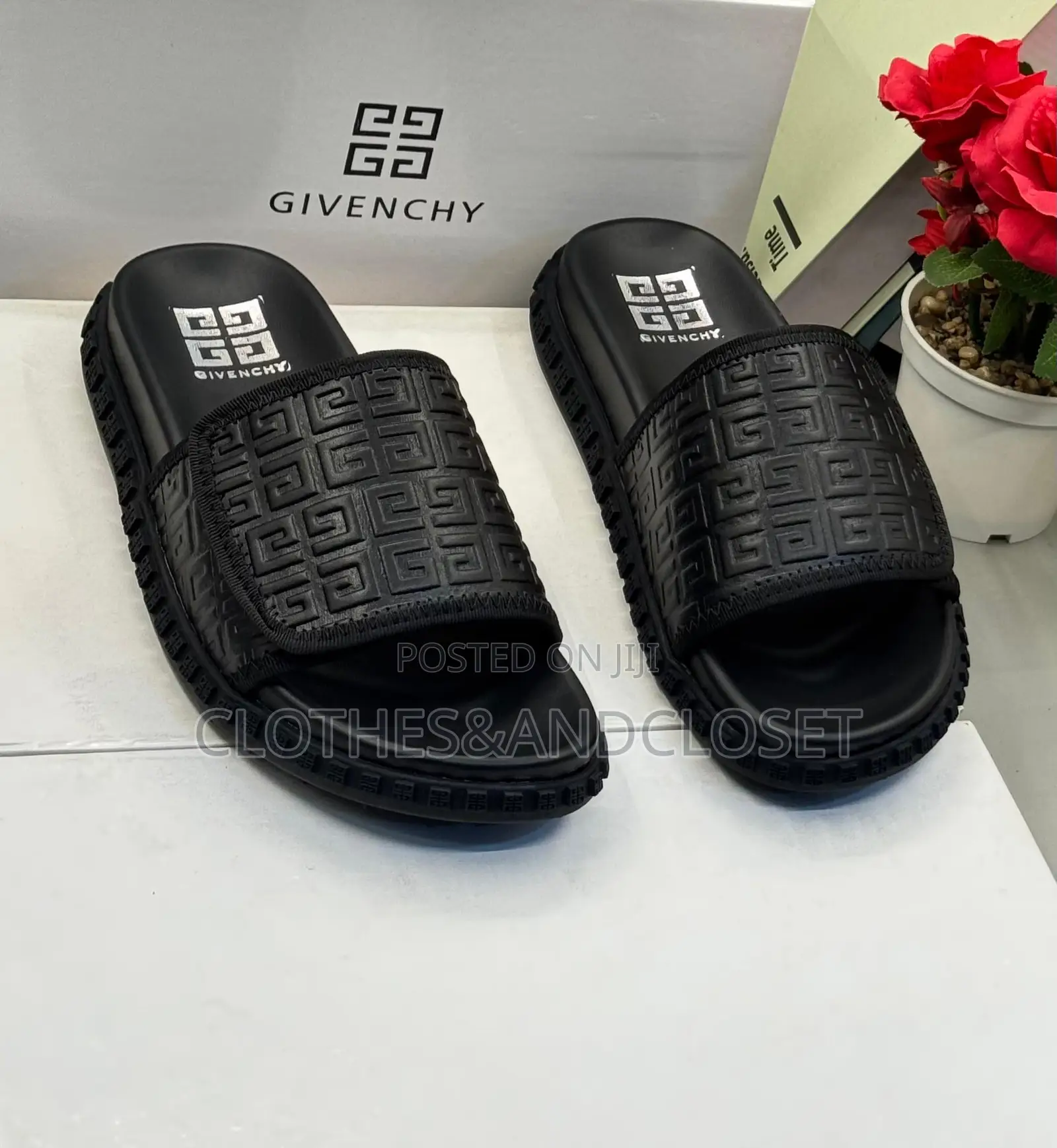 Black Givenchy Slides Feature a Prominent Monogram Embossed Pattern