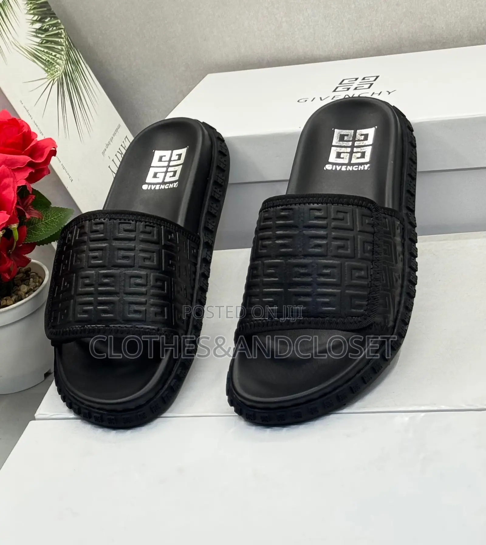 Black Givenchy Slides Feature a Prominent Monogram Embossed Pattern