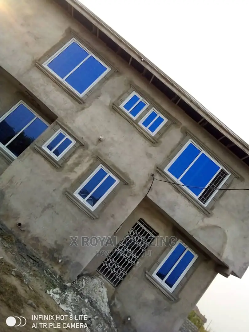 White Italian Frame Sliding Windows With Blue Glass.
