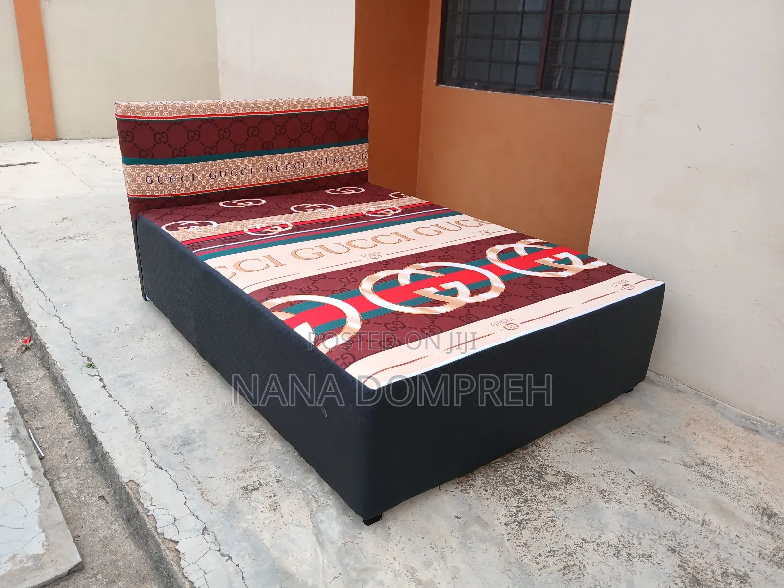 Gucci on Black Bed.