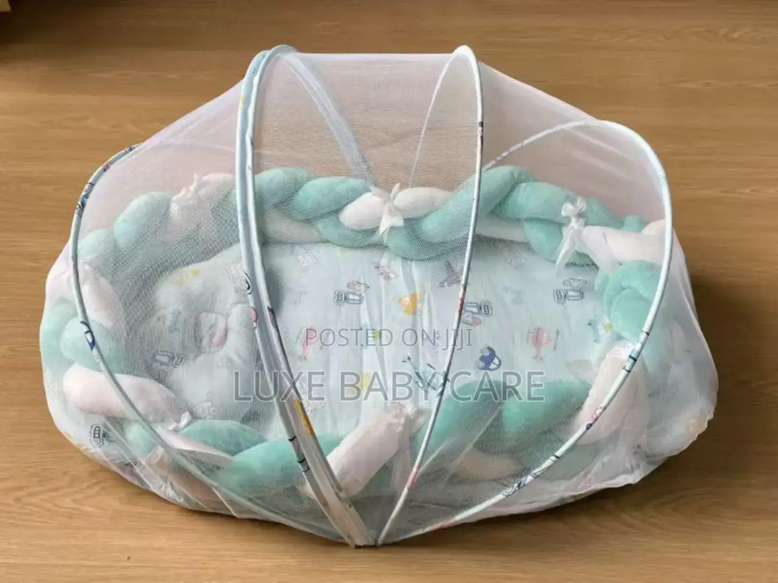 Baby Bed With a Mosquito Net and a Braided Bumper Guard.