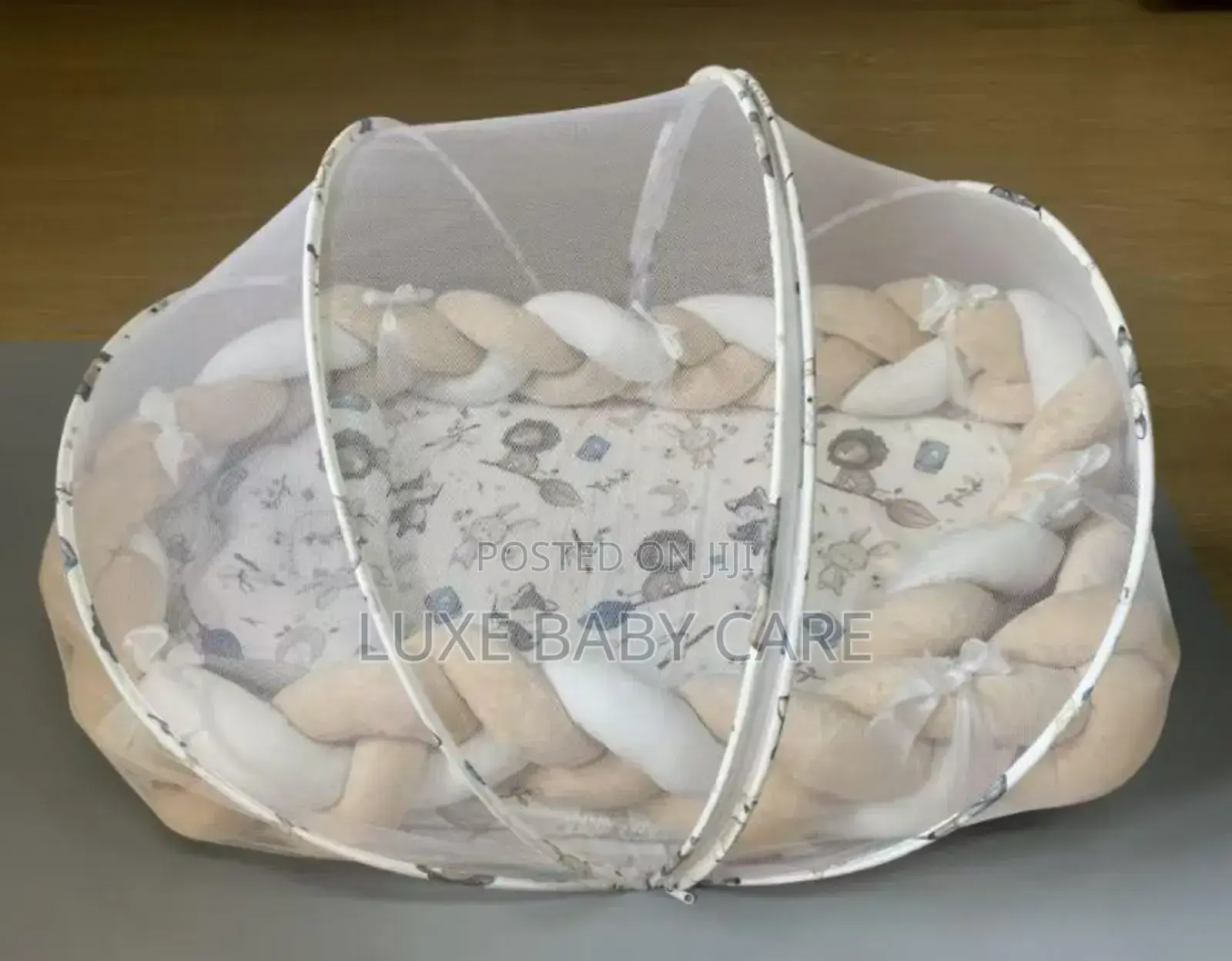 Baby Bed With a Mosquito Net and a Braided Bumper Guard.