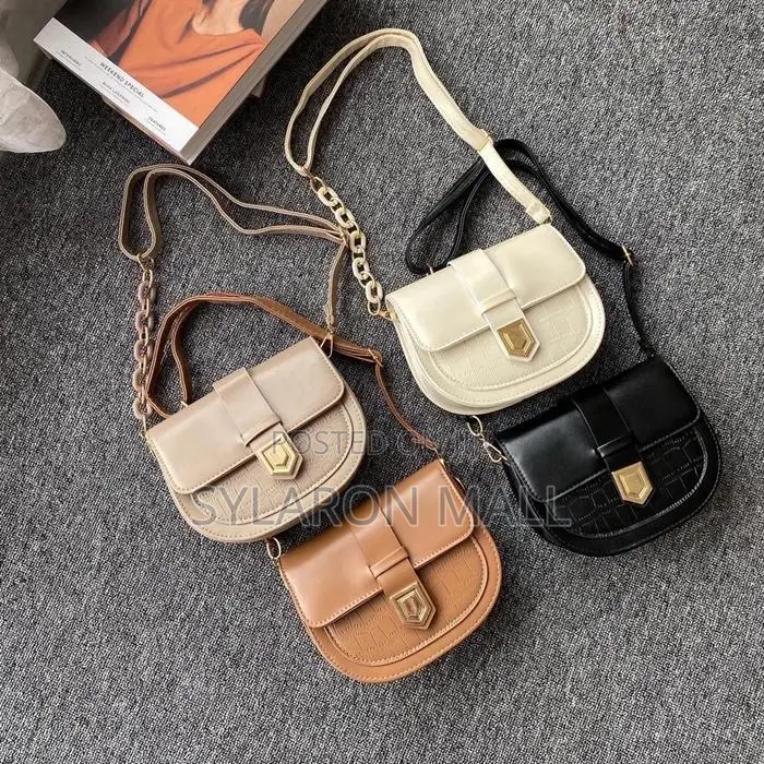Compact Buckle-Flap Saddle Bag – Tan With Chain Accent