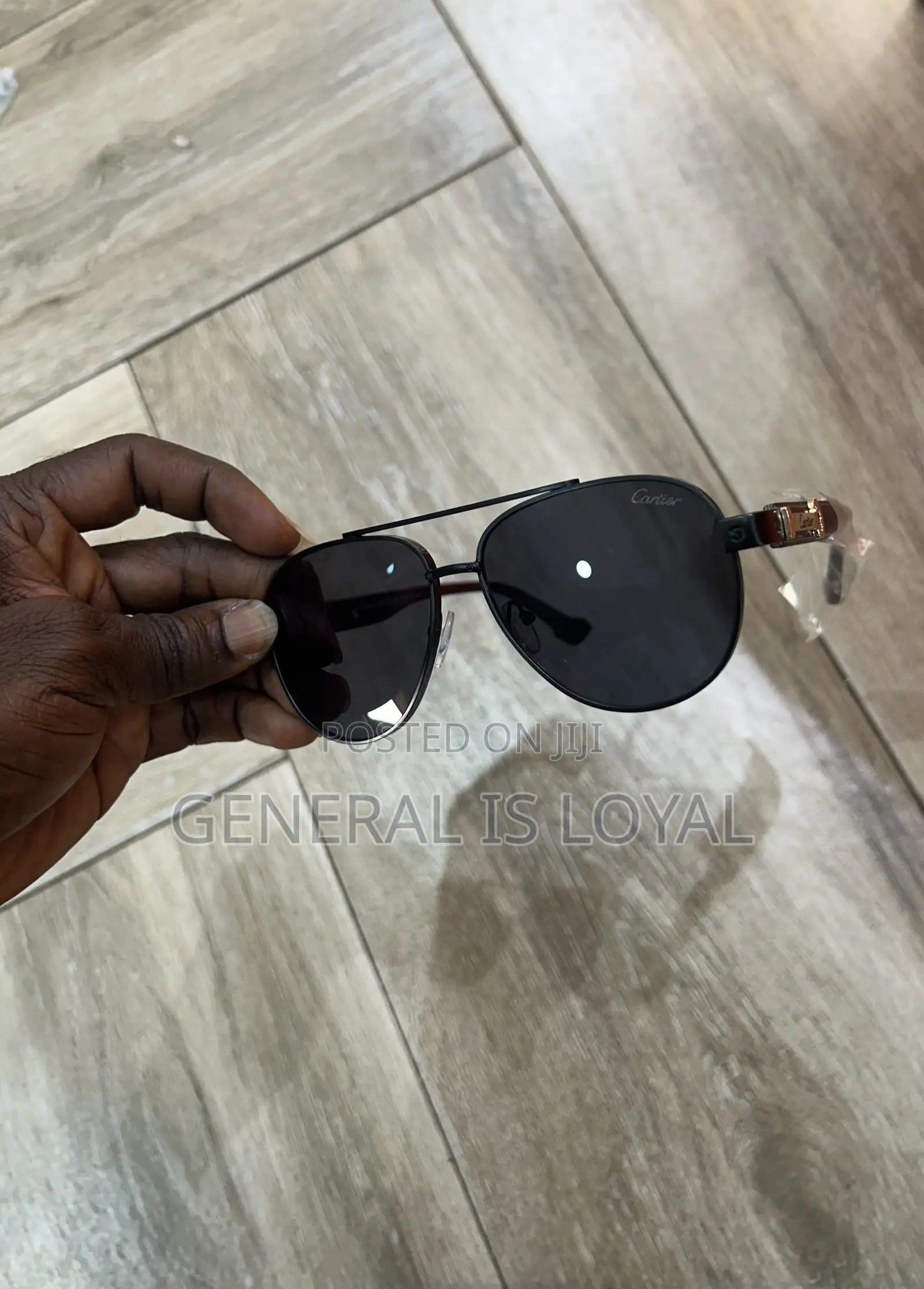 Cartier Aviator Sunglasses With A Black Metal Frame And Dark Lenses.