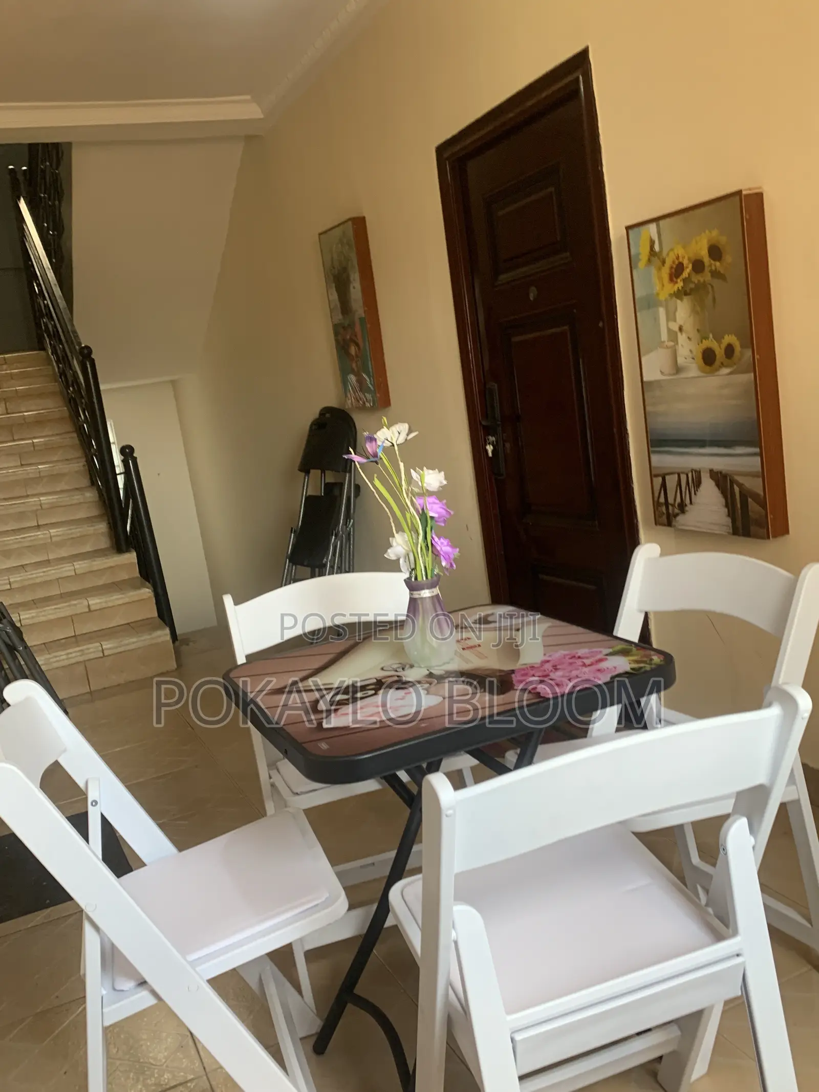 Table With a Decorative Glass Top With 4 Kinds of Folding Chairs.