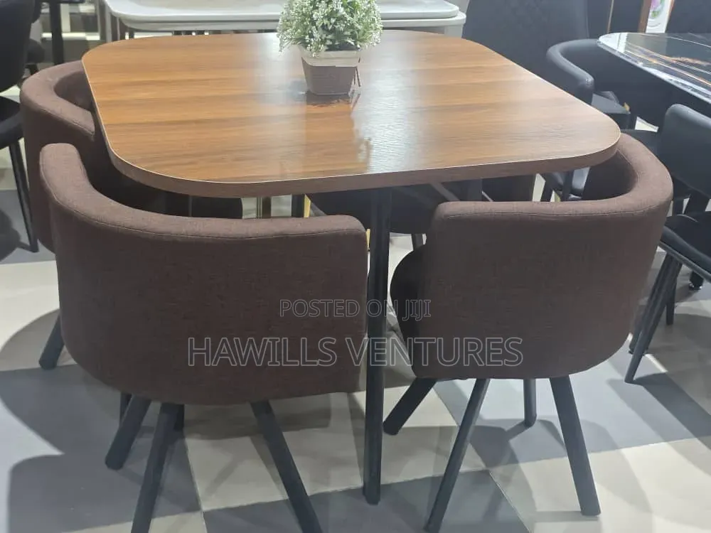 Modern Dining Set Features a Square Wooden Table With Dark Legs