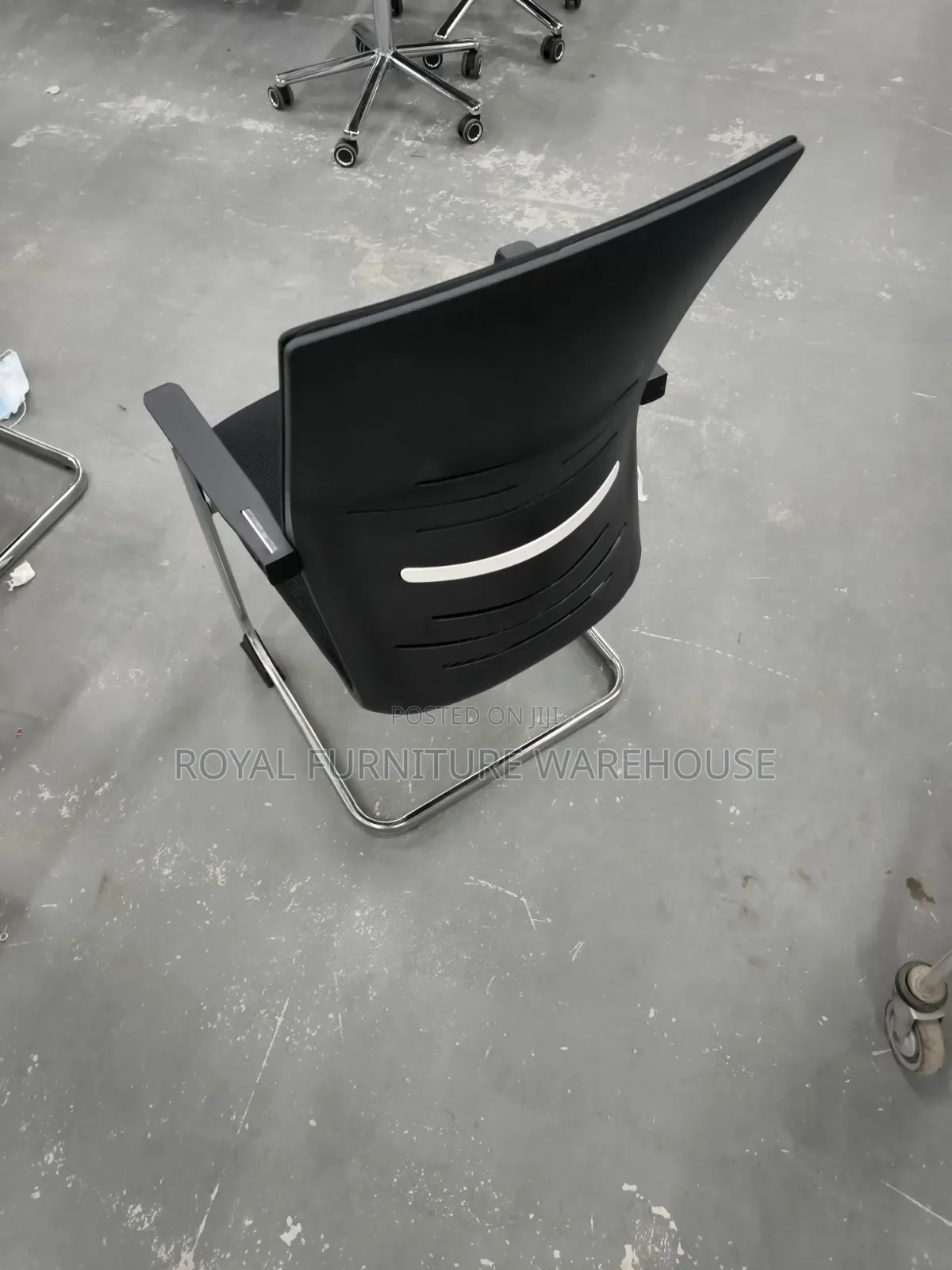 Black Cantilever Visitor's Or Conference Chair With A Chrome Frame.
