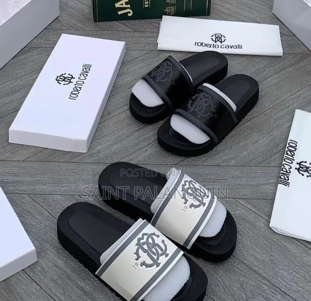 The Image Shows a Pair of Black and White Roberto Cavalli Slides