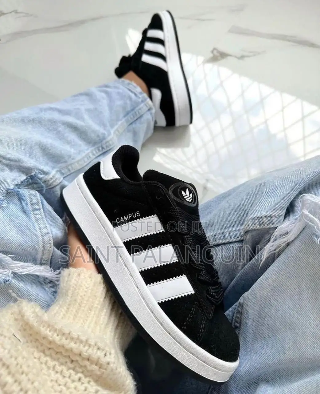 The Image Shows a Pair of Black and White Adidas Campus Sneakers