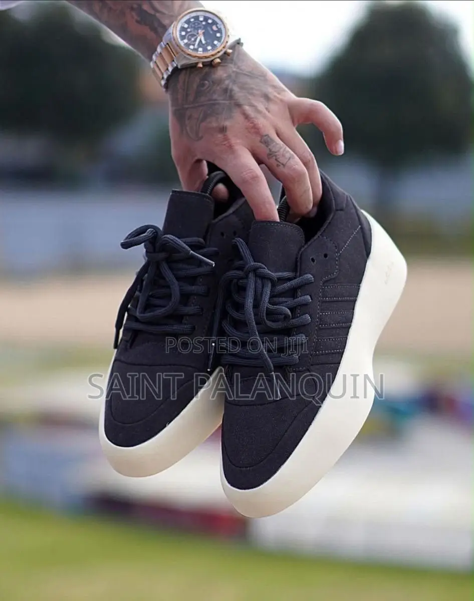 Apair of Black Adidas X Fear of God Athletics Sneakers