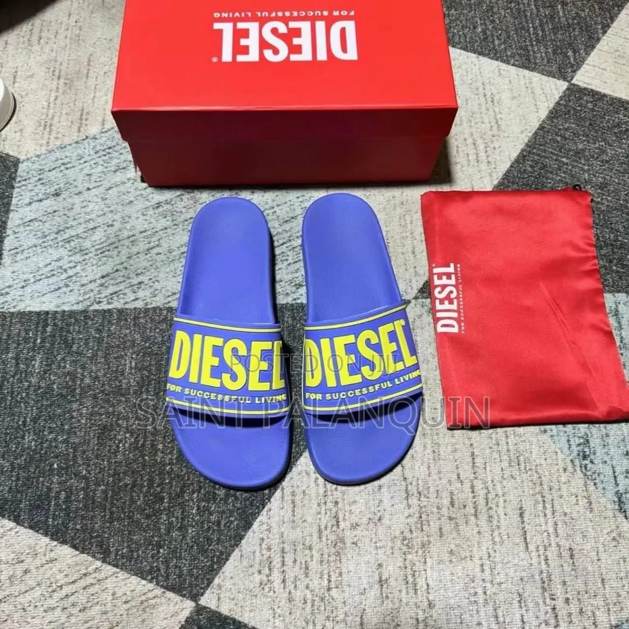 A Pair of Blue Diesel SA-Mayemi CC Slide Sandals