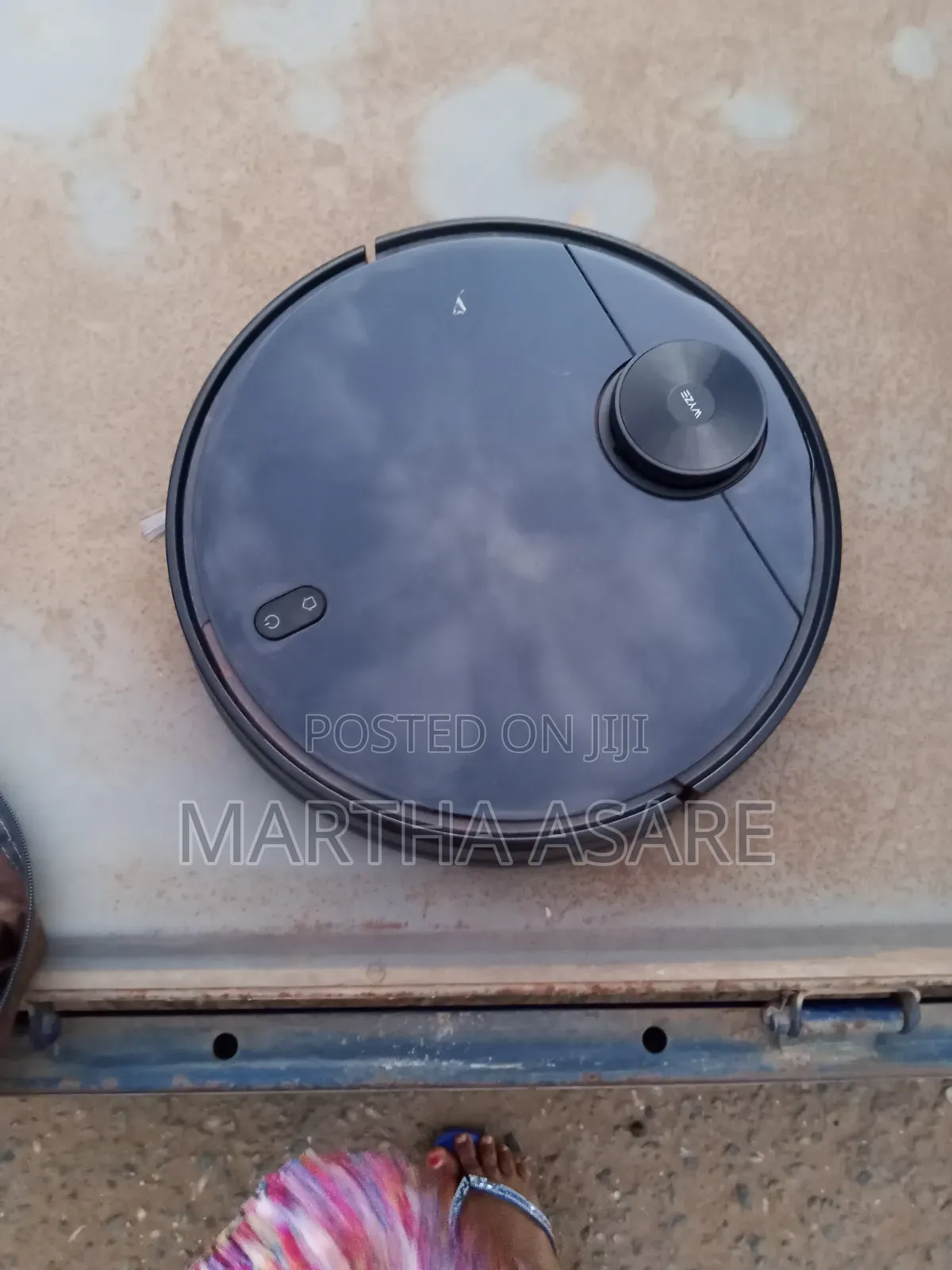 The Image Shows a Wyze Robot Vacuum, a Smart Automated Cleaning Device