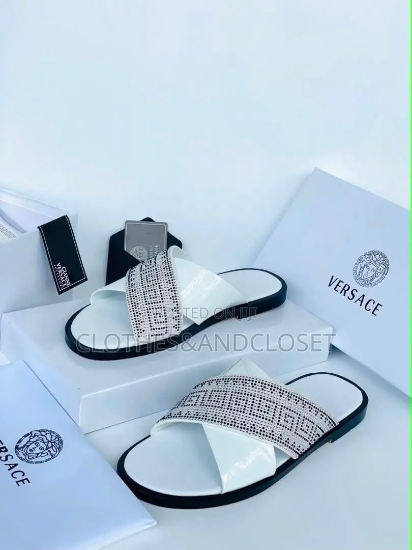 Stylish Black Leather Slides Feature a Striking Cross-Strap Desig