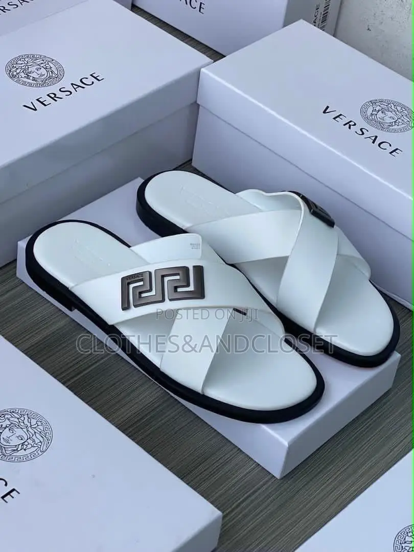 Stylish Black Leather Slides Feature a Striking Cross-Strap Desig