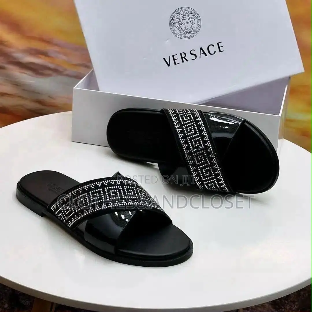 Stylish Black Leather Slides Feature a Striking Cross-Strap Desig