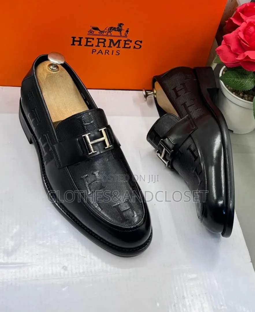 Black Leather Hermès Paris Men's Loafers Featuring a Signature Metalli