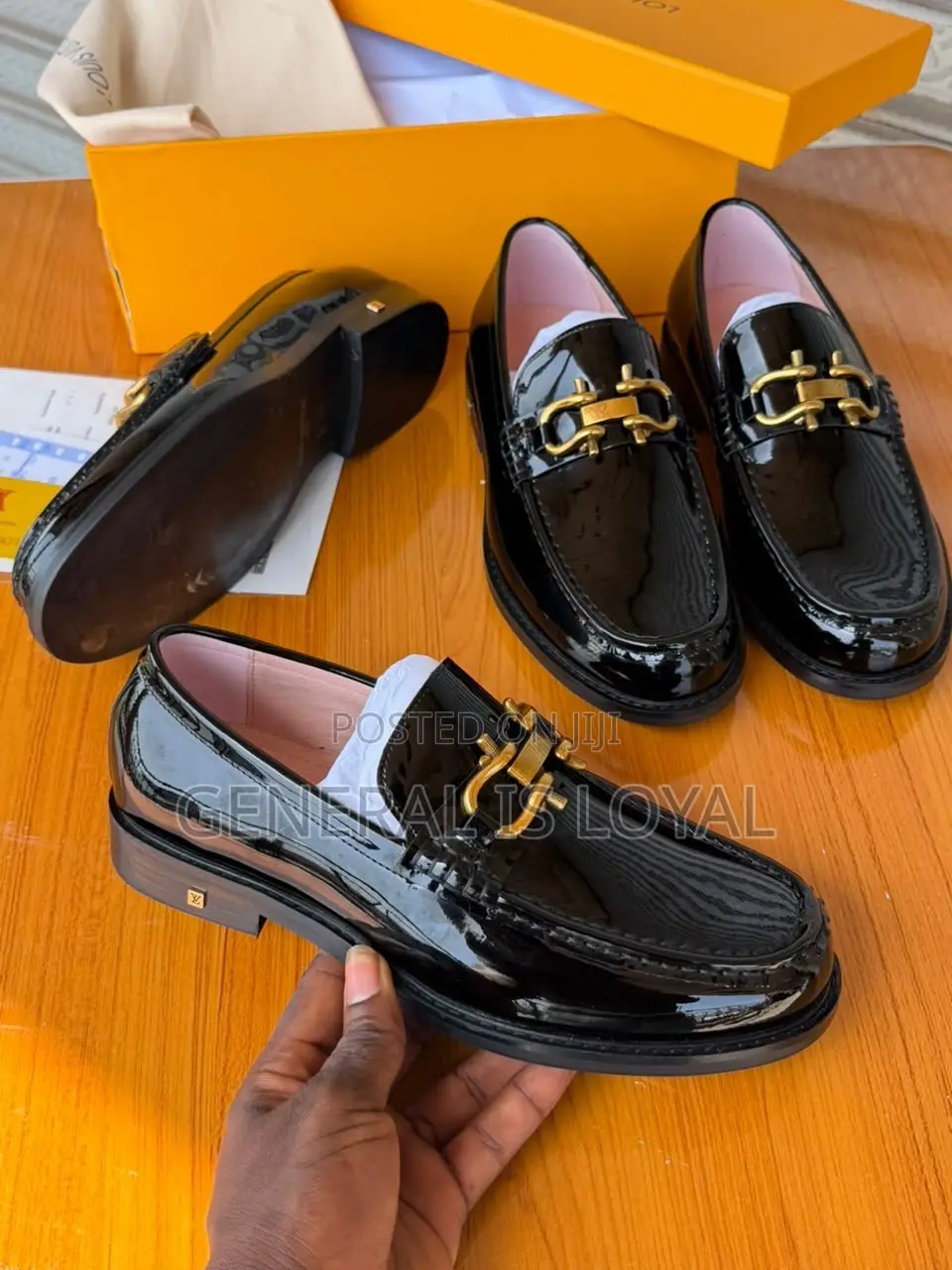 Black Patent Leather Loafers Mirror a Gold-Tone Metallic Buckle