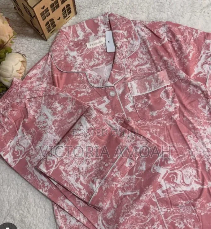 A Pink and White Printed Long- Sleeve Button- Down Pajama Set.